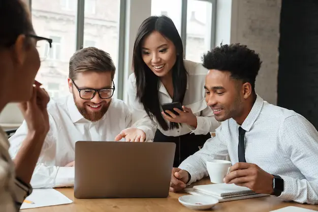 cherful positive young colleagues using laptop computer 171337 753