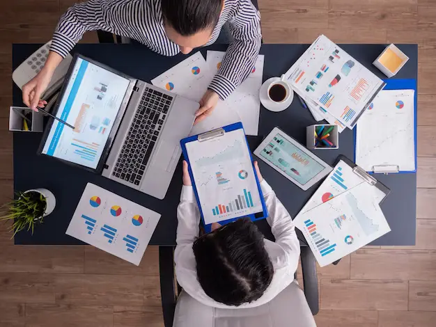 top viewtop view manager employee doing teamwork business office looking charts laptop display 482257 2443